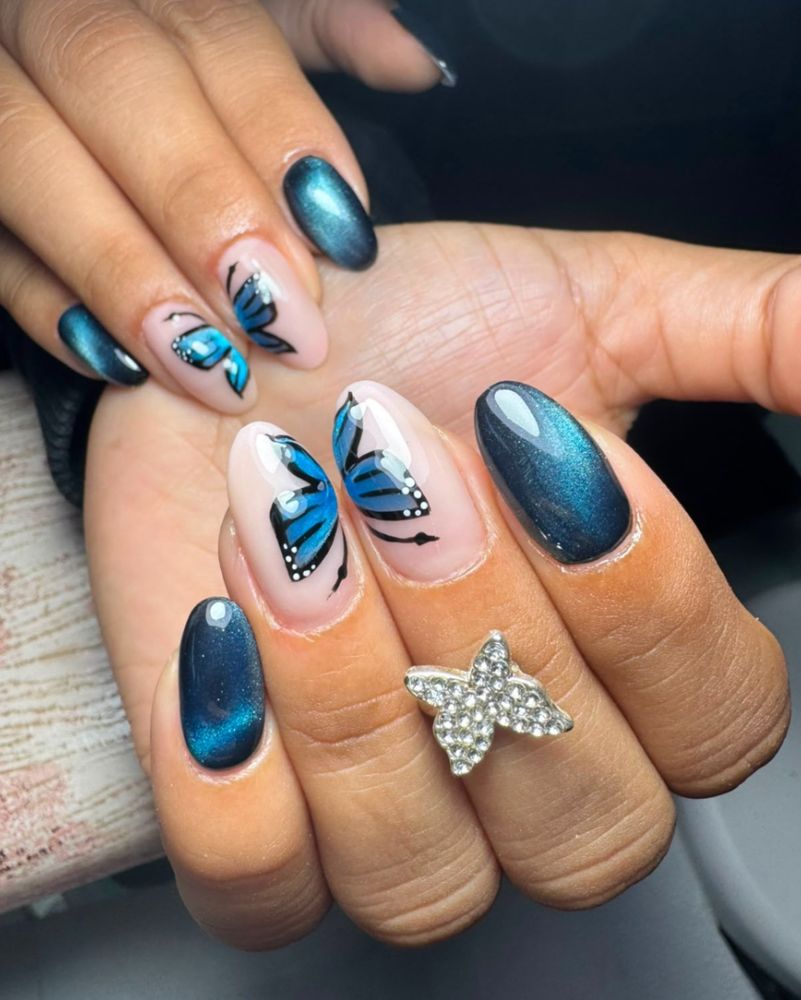 Nail art de mariposas con cat-eye azul